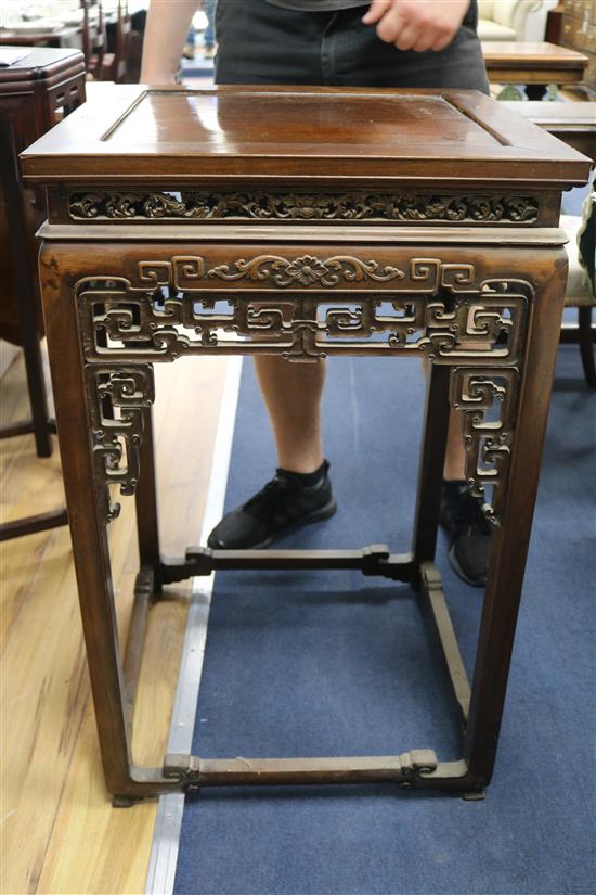 A Chinese huali wood urn stand, having panelled top and pierced frieze W.52cm